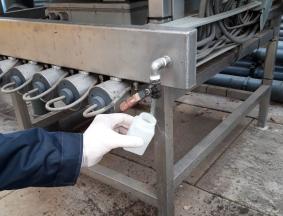 Hands disinfecting farm equipment